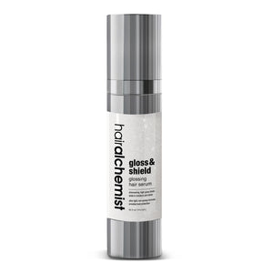 Hair alchemist gloss & shield hair serum bottle on a white background