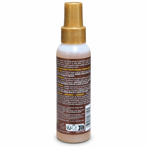 A bottle of hair developer shown from the back, featuring a gold spray nozzle and a brown label with white and yellow text.