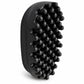 A black silicone scalp massage brush with multiple raised nubs, shown at an angle on a white background.