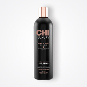 Black shampoo bottle with rose gold cap on a white background