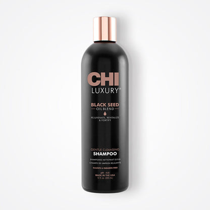 Black shampoo bottle with rose gold cap on a white background