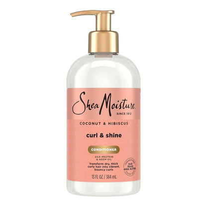 Shea Moisture Coconut & Hibiscus Curl & Shine Conditioner in a 15 fl oz clear bottle with a peach-pink label and a gold pump dispenser, shown on a white background.