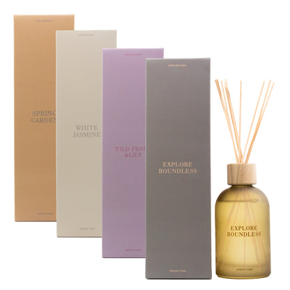 Set of diffuser bottles and boxes with 'Explore Boundless' branding on a white background