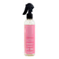 Bottle with pink label and black spray nozzle on a white background