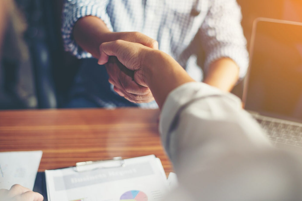 Business partnership handshake