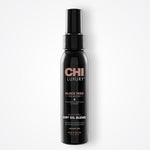 Black bottle of CHI Luxury Black Seed Dry Oil Blend on a white background
